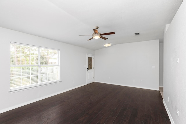 spare room featuring dark wood-type flooring, ceiling fan, and vaulted ceiling