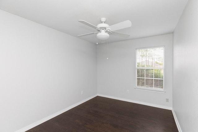 empty room with dark wood-type flooring and ceiling fan