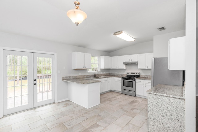 kitchen featuring plenty of natural light, white cabinetry, vaulted ceiling, and stainless steel appliances