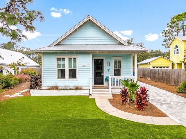 bungalow with a front yard and covered porch