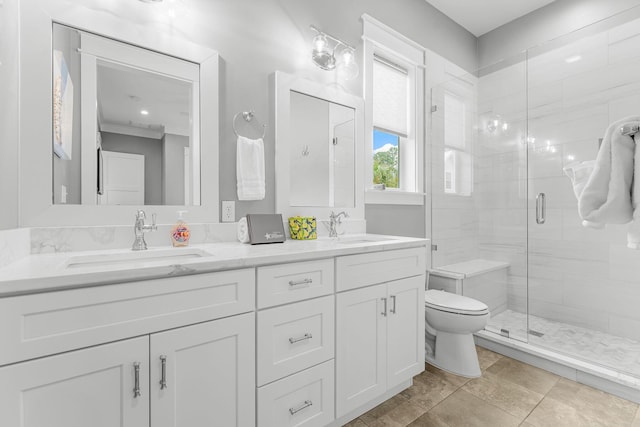 bathroom with vanity, toilet, and a shower with door