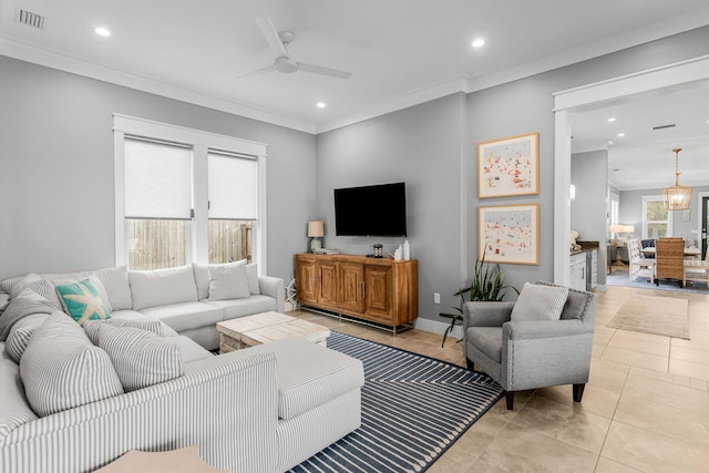 tiled living room with ornamental molding and ceiling fan