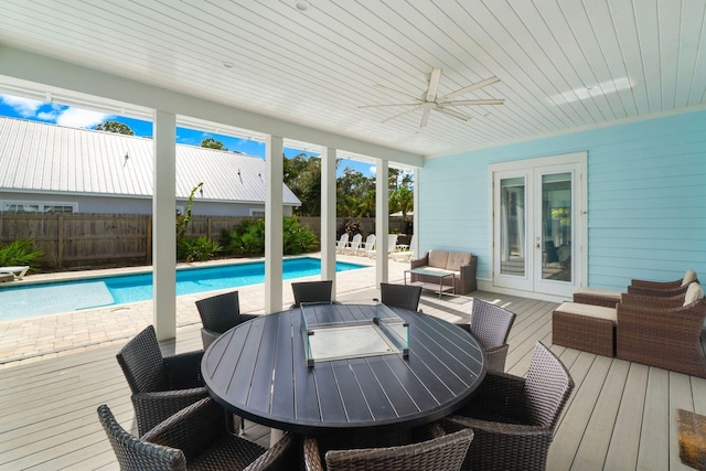 view of swimming pool featuring an outdoor hangout area, french doors, ceiling fan, and a wooden deck