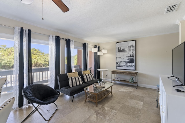 living room with a textured ceiling and ceiling fan