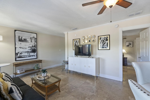 living room with a textured ceiling, ceiling fan, and crown molding