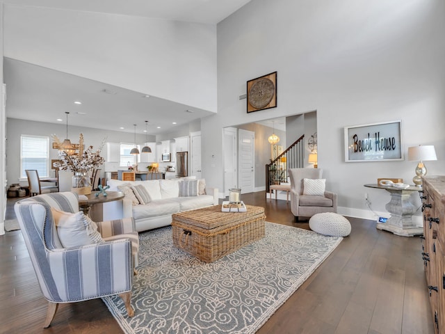 living room featuring dark hardwood / wood-style floors and a towering ceiling