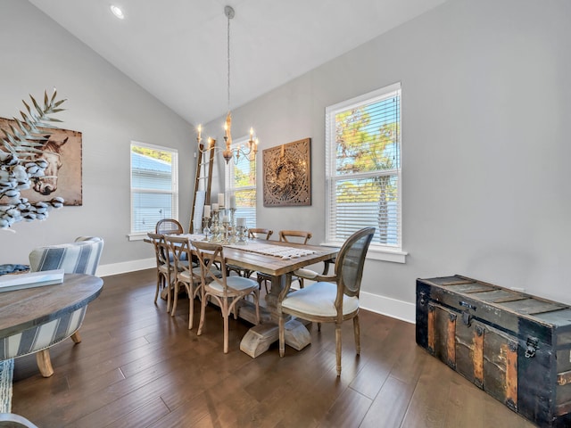 dining space featuring lofted ceiling, dark hardwood / wood-style floors, and a notable chandelier