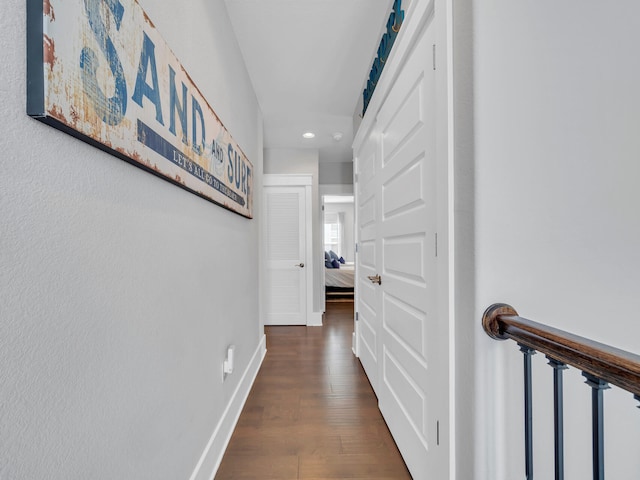 corridor with dark hardwood / wood-style floors