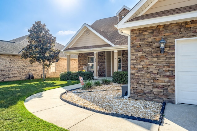 property entrance featuring a garage and a yard