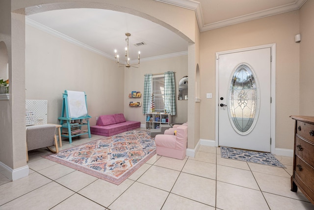 foyer entrance featuring a chandelier, light tile patterned floors, and ornamental molding