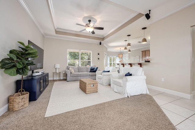 living room featuring a tray ceiling, light colored carpet, and crown molding