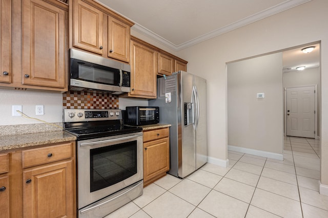 kitchen featuring stainless steel appliances, decorative backsplash, light tile patterned floors, crown molding, and light stone countertops