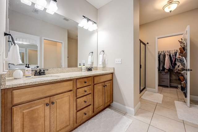 bathroom featuring vanity, tile patterned floors, and an enclosed shower