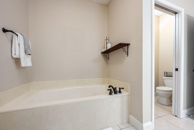 bathroom featuring a tub, tile patterned flooring, and toilet