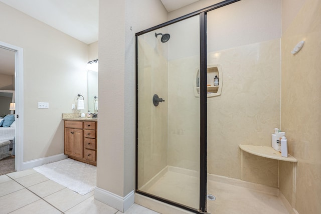 bathroom featuring walk in shower, vanity, and tile patterned flooring