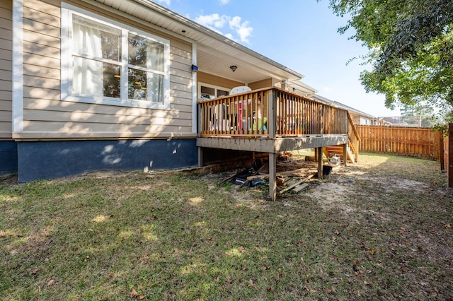 view of side of home with a lawn and a deck