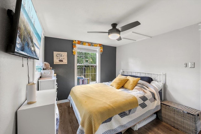 bedroom with dark hardwood / wood-style flooring and ceiling fan