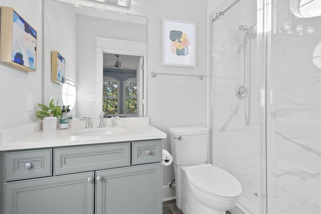 bathroom with toilet, vanity, lofted ceiling, and a shower with shower door