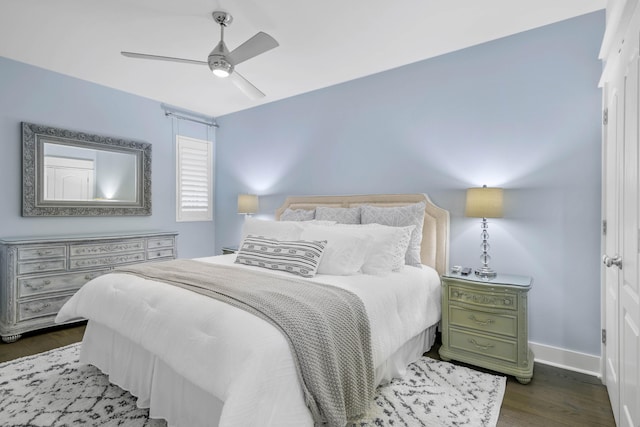 bedroom with ceiling fan and dark hardwood / wood-style floors