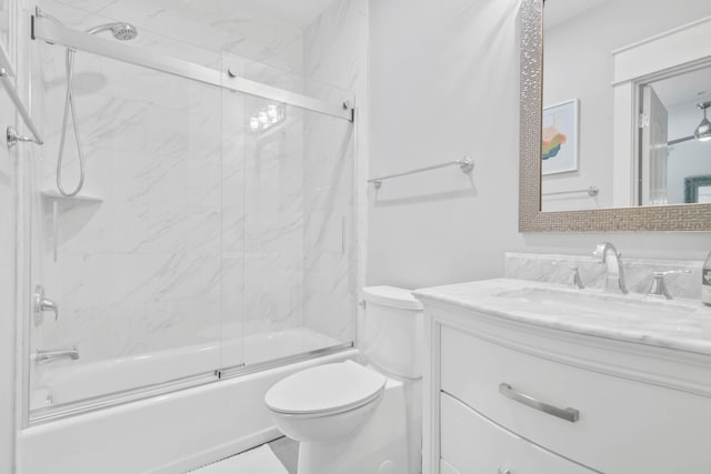 full bathroom featuring toilet, bath / shower combo with glass door, and vanity