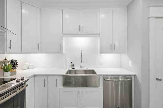 kitchen with sink, backsplash, stainless steel appliances, and white cabinets