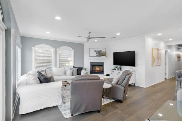 living room with ceiling fan and dark hardwood / wood-style floors