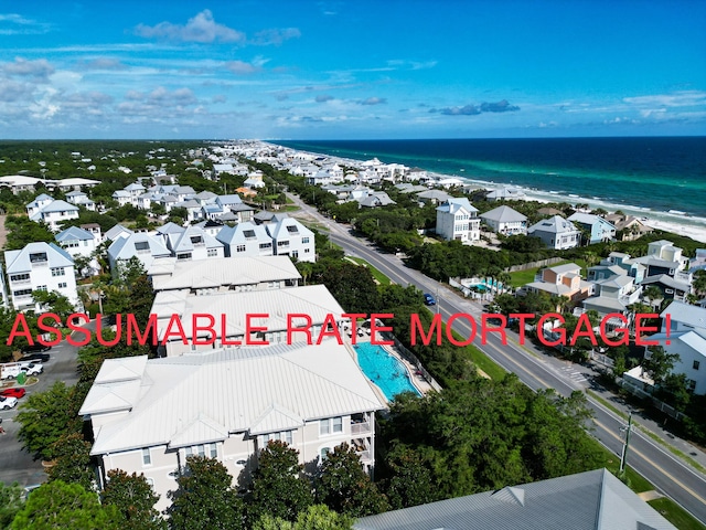 birds eye view of property featuring a view of the beach and a water view