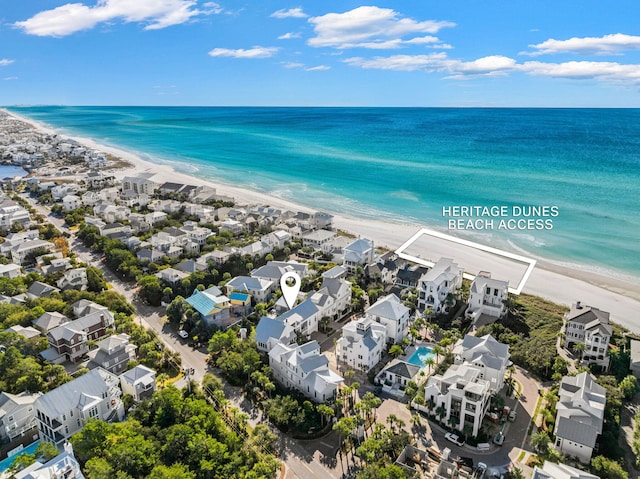 birds eye view of property with a beach view and a water view