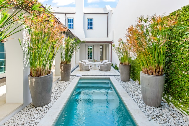 rear view of property with a patio area and outdoor lounge area