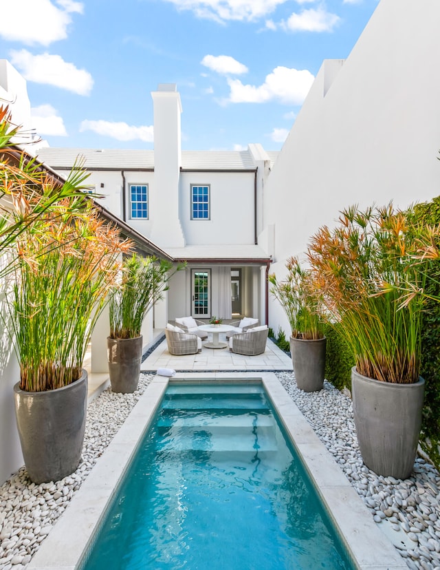 back of house featuring a patio and an outdoor living space