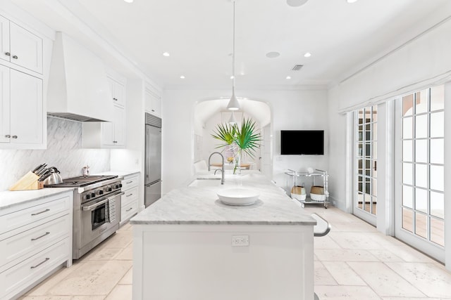 45 N Charles St, Inlet Beach, FL 32461 - kitchen featuring high end appliances, premium range hood, tasteful backsplash, a kitchen island with sink, and white cabinets