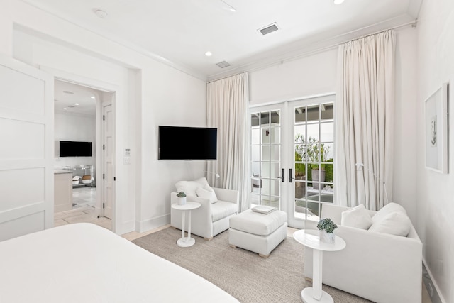 bedroom with ornamental molding and french doors