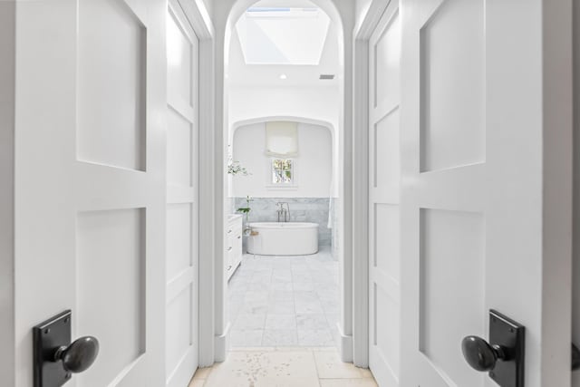 45 N Charles St, Inlet Beach, FL 32461 - corridor with arched walkways and light marble finish floors