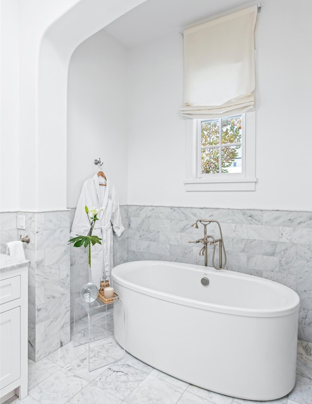45 N Charles St, Inlet Beach, FL 32461 - full bath with tile walls, marble tiled flooring, wainscoting, and a soaking tub