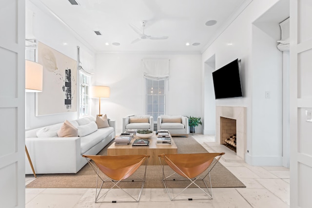 living room with ceiling fan and crown molding