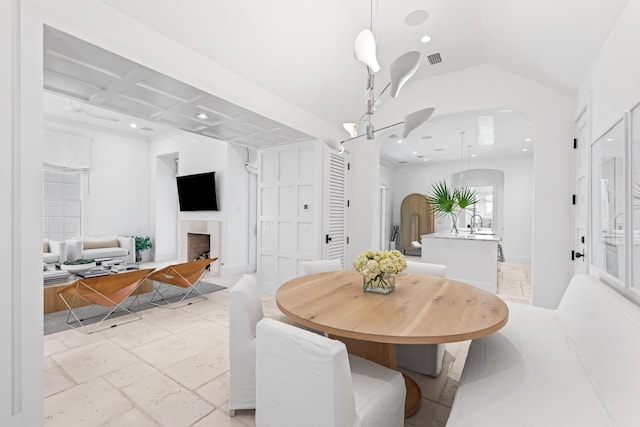 45 N Charles St, Inlet Beach, FL 32461 - dining room featuring arched walkways, a fireplace, recessed lighting, and lofted ceiling