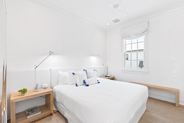 bedroom with ceiling fan and light carpet