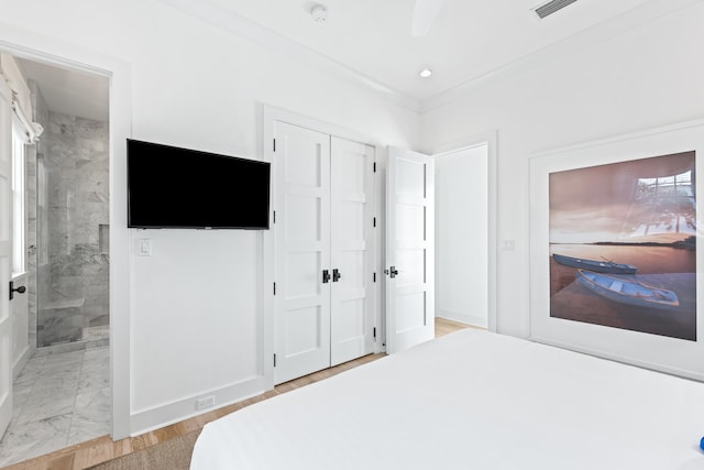 bedroom featuring ensuite bath and ceiling fan