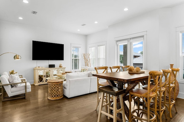 dining area with dark hardwood / wood-style flooring and plenty of natural light