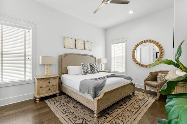 bedroom featuring multiple windows, ceiling fan, and dark hardwood / wood-style flooring