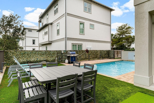 view of swimming pool with a lawn, a patio, and grilling area