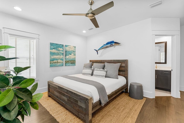 bedroom with ceiling fan, light hardwood / wood-style floors, and ensuite bath