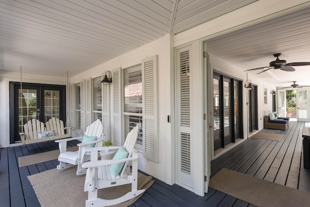 deck featuring ceiling fan, french doors, and covered porch