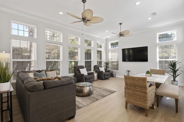 sunroom featuring ceiling fan and plenty of natural light