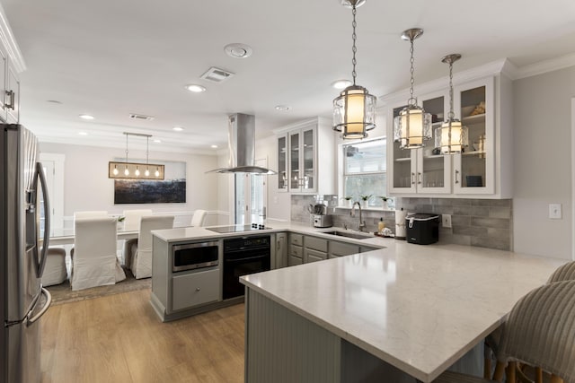 kitchen featuring island range hood, kitchen peninsula, and black appliances