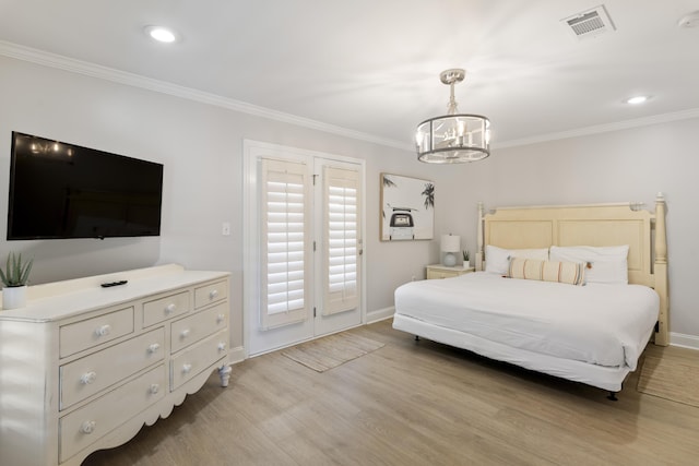 bedroom featuring crown molding, a chandelier, and light wood-type flooring