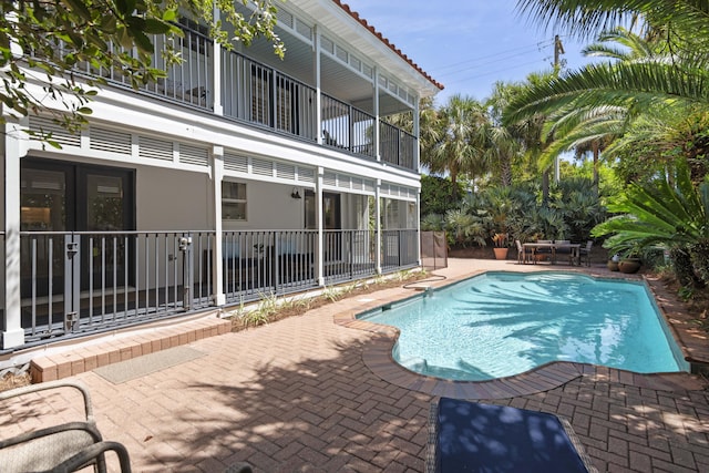 view of swimming pool featuring a patio area