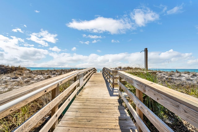 view of dock with a view of the beach and a water view