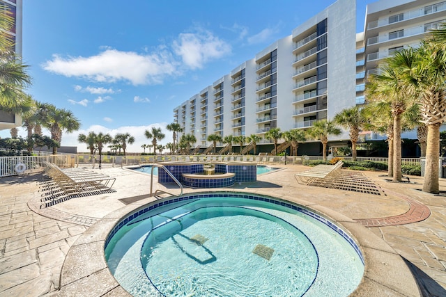 view of swimming pool featuring a community hot tub