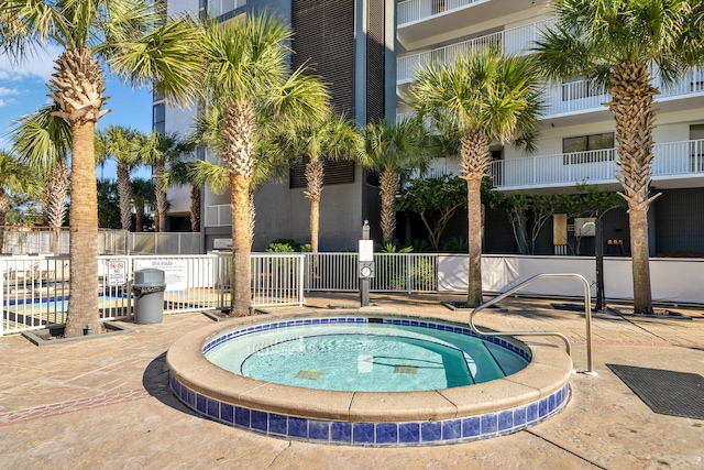 view of swimming pool with a community hot tub